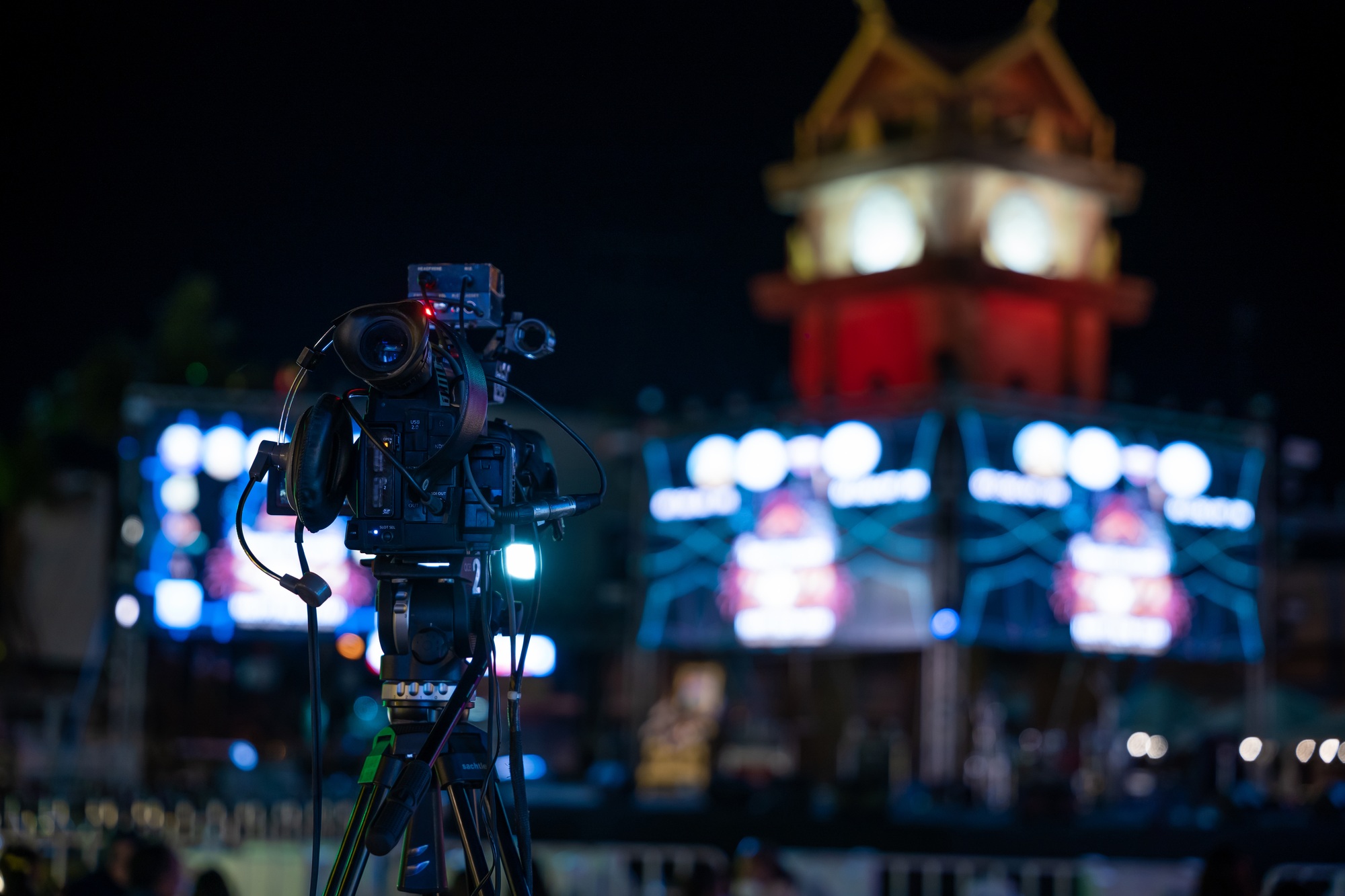 Professional video crew filming live event on stage. Expertise in movie production television